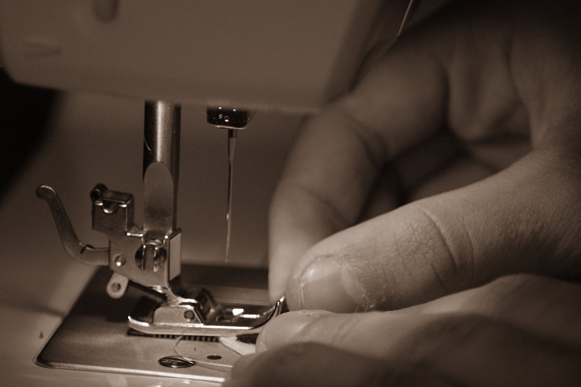 Close up of someone's hands using a sewing machine